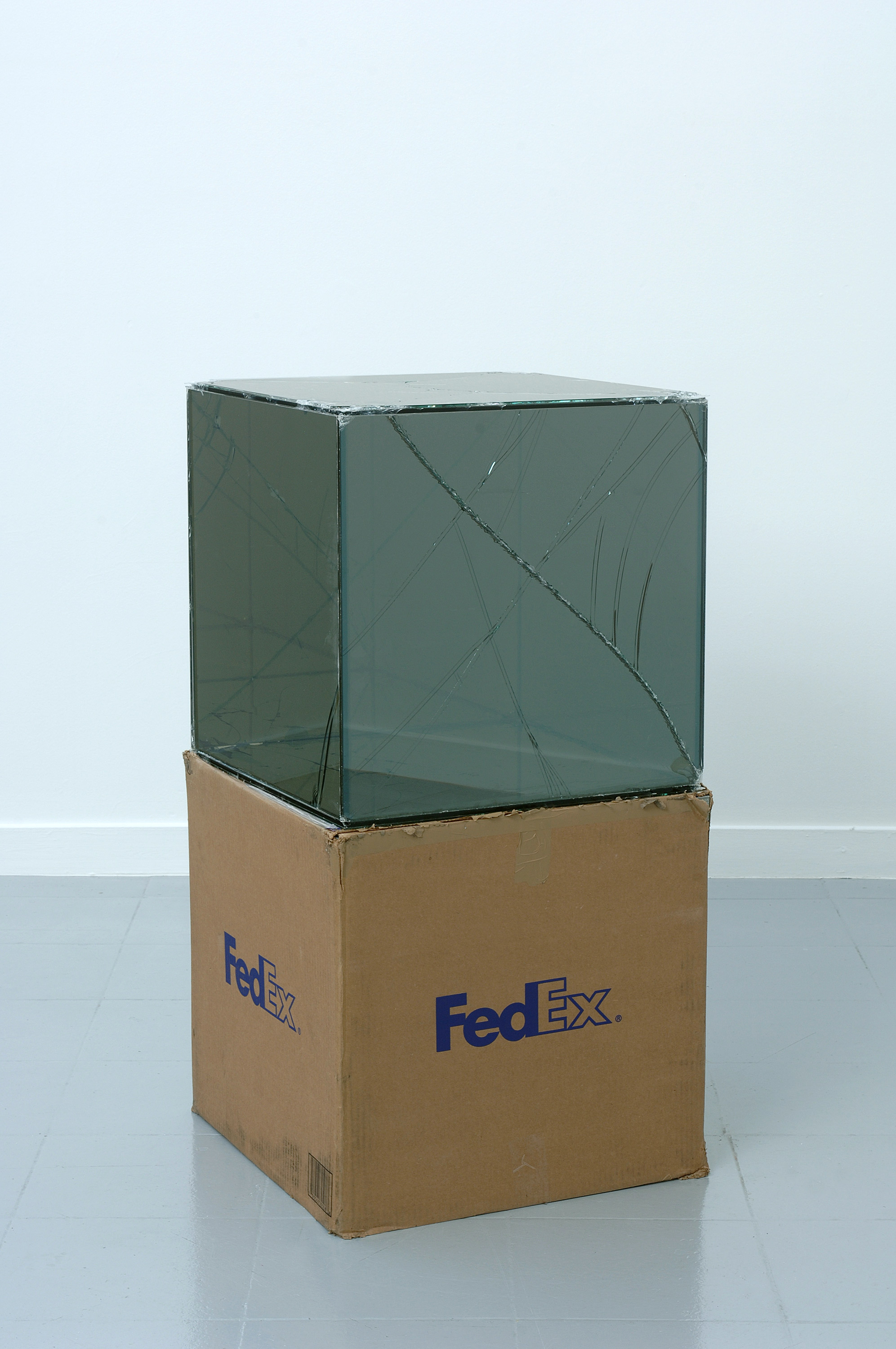   FedEx® Large Kraft Box  © 2005 FEDEX 330508 REV 10/05 SSCC, International Priority, Los Angeles–Brussels trk#865282057942, October 27–30, 2008    2008–   Laminated Mirropane, FedEx shipping box, accrued FedEx shipping and tracking labels, silicone,