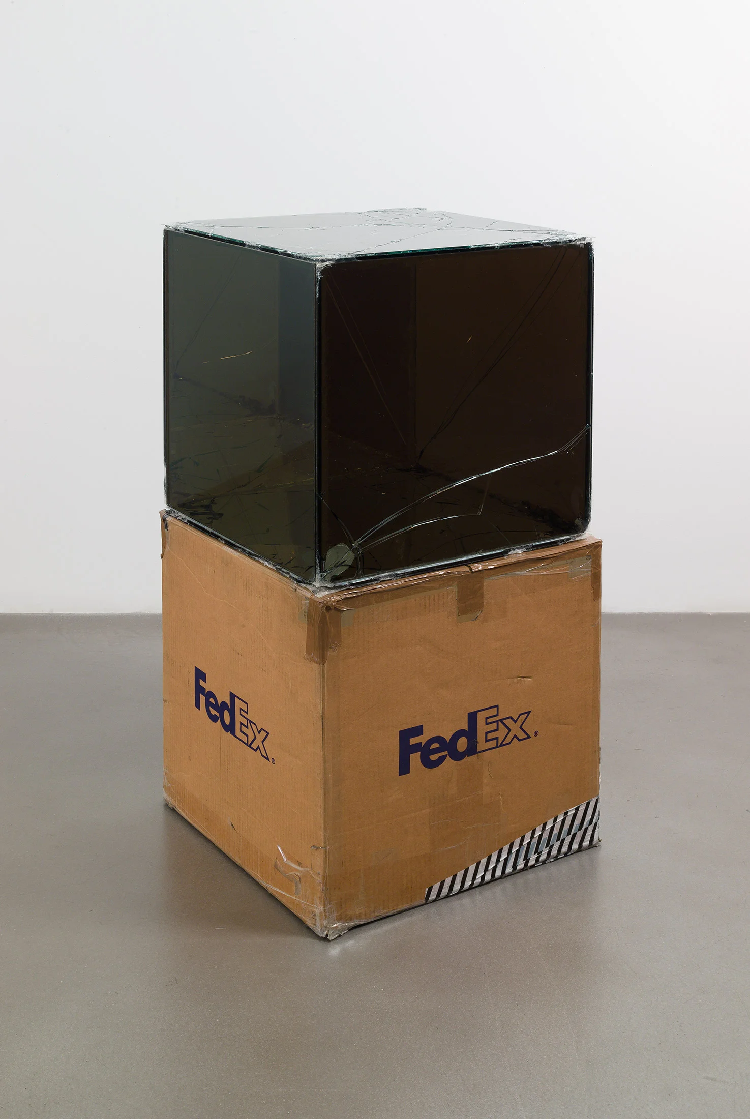 FedEx® Large Kraft Box © 2005 FEDEX 330508 REV 10/05 SSCC, Standard Overnight, Los Angeles–Oak Park trk#865344981196, September 17–18, 2008, Standard Overnight, Oak Park–Los Angeles trk#865326699753, March 12–13, 2009, Standard Overnight, Los Angeles–New York trk#774901624186, November 4–5, 2015, Standard Overnight, New York–Los Angeles trk#775241295627, December 21–22, 2015 2008– Laminated Mirropane, FedEx shipping box, accrued FedEx shipping and tracking labels, silicone, metal, tape 20 x 20 x 20 inches Great Hall Exhibition, 2015