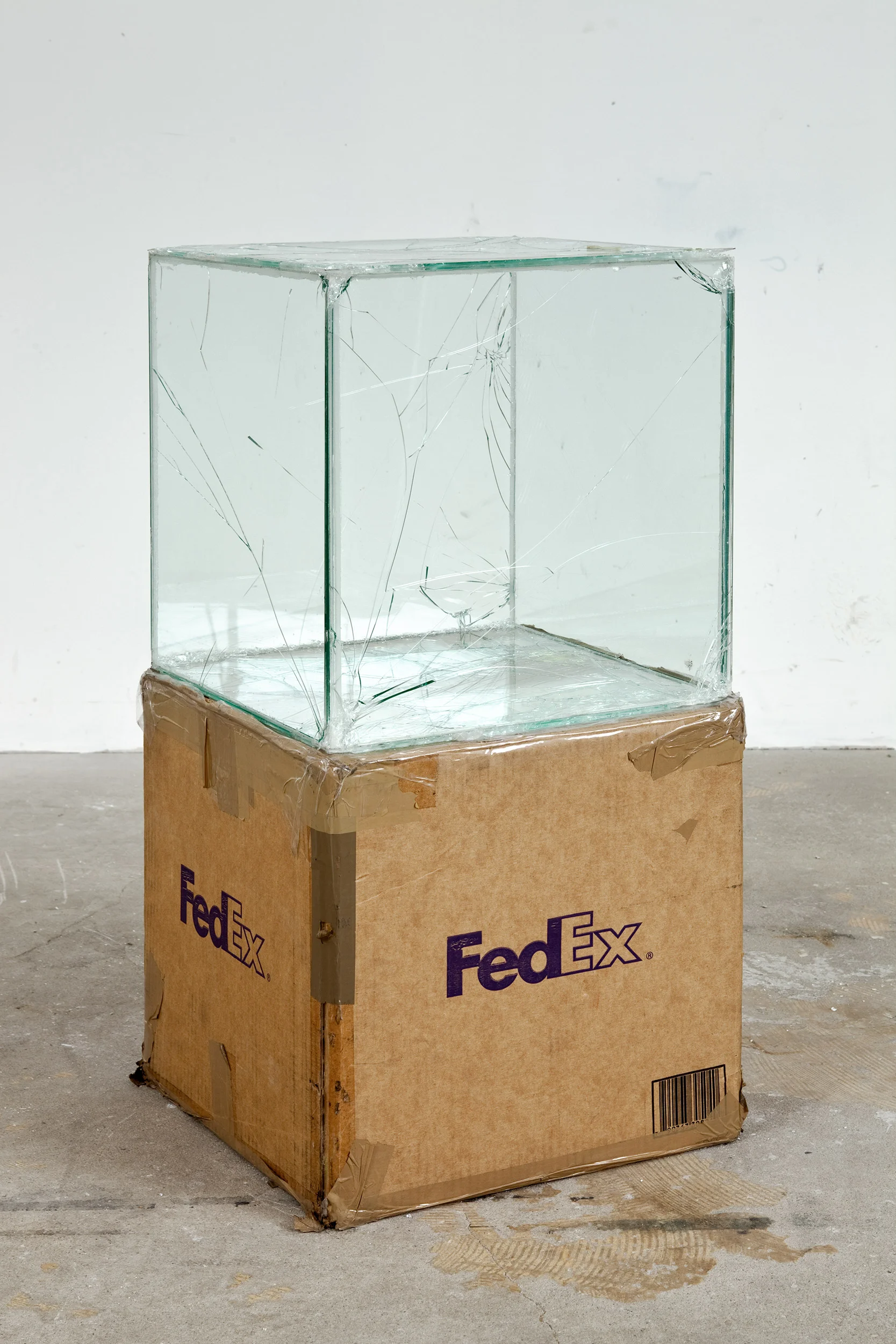 FedEx Kraft Box 2005 FEDEX 330504 10/05 SSCC, Priority Overnight, Los Angeles-Miami trk#865344981299, October 29–30, 2008, Priority Overnight, Miami–Ann Arbor trk#861049125115, March 03–04, 2009, Standard Overnight, Ann Arbor–Los Angeles trk#868274625749, July 09–10, 2009, Standard Overnight, Los Angeles–San Francisco trk#878069766471, August 27–28, 2009, Standard Overnight, San Francisco–Los Angeles trk#870342520145, November 12–13, 2009, International Priority, Los Angeles–London trk#798269222978, April 10–12, 2012 2008– Laminated glass, FedEx shipping box, accrued FedEx shipping and tracking labels, silicone, metal, tape 16 x 16 x 16 inches FedEx Glass Works, 2007– Pulley, Cogwheels, Mirrors, and Windows, 2009