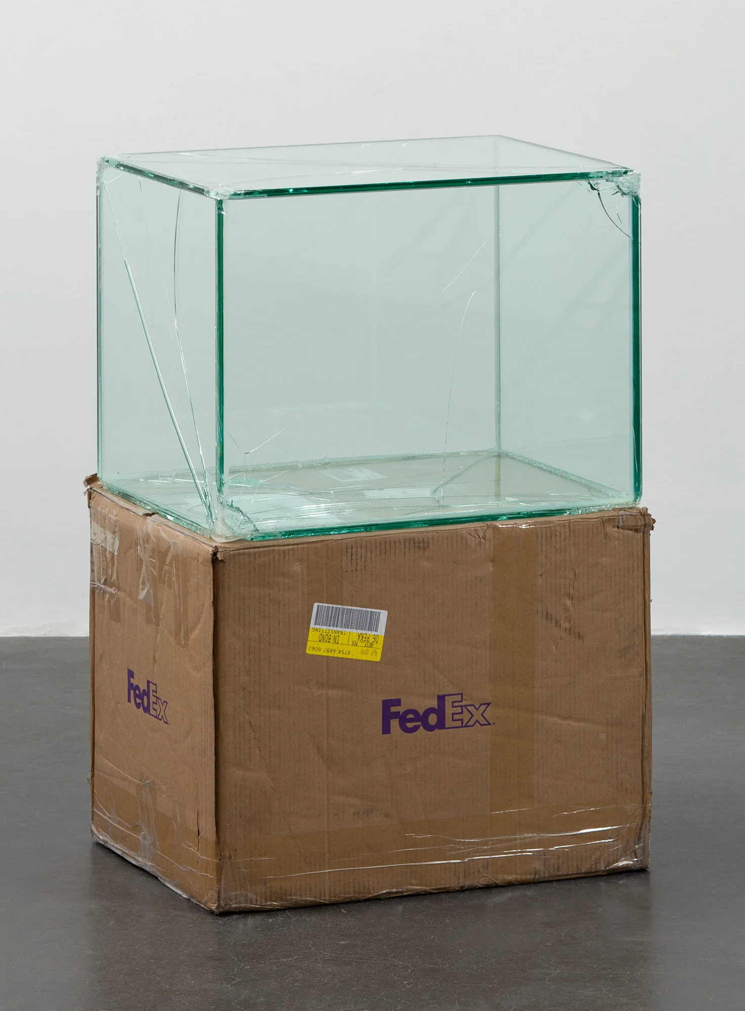 FedEx® Large Kraft Box © 2004 FEDEX 155143 REV 10/04 SSCC, International Priority, Los Angeles-Beijing trk#875468976062, September 9–14, 2011, International Priority, Bejing–London trk#874594463978, March 13–15, 2012 2011– Laminated glass, FedEx shipping box, accrued FedEx shipping and tracking labels, silicone, metal, tape 23 5/8 x 18 1/2 x 18 1/2 inches Securities and Exchanges, 2011
