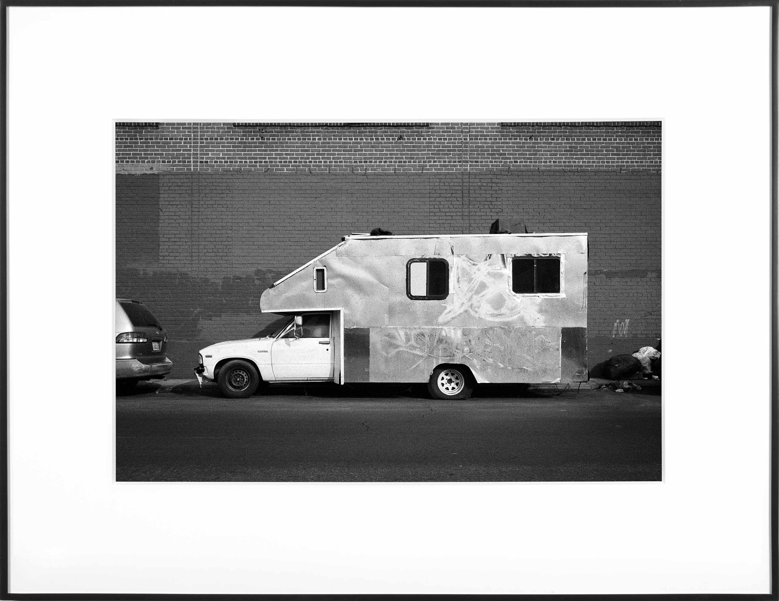   (Temporary) Homes for America: 3300 block to 4400 block, Union Pacific Avenue, between South Grande Vista Avenue and South Marianna Avenue, Los Angeles/Commerce, California, December 2020   2021  black and white fiber print  11 x 15 inches  Exhibit