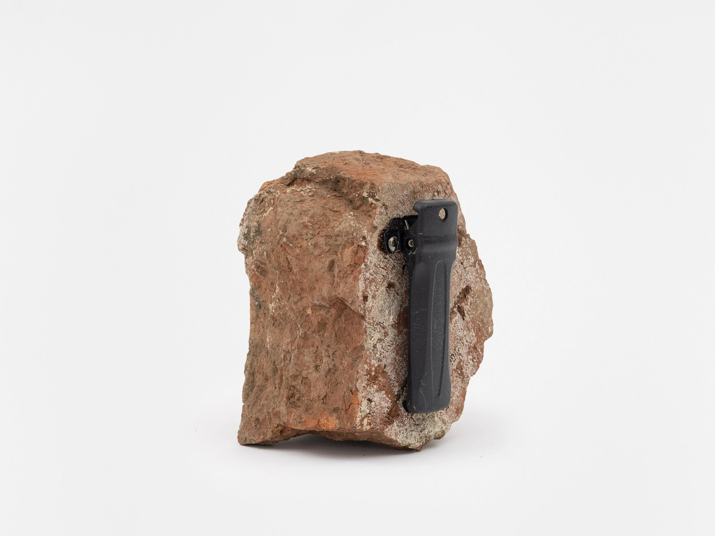 Cell Device (Pager): 8017 Mulholland Drive, Los Angeles, California 2024 brick, pager belt clip, and screws 3 x 4 ½ x 3 ½ inches Smart Objects, 2024 Exhibition: Profit & Loss, 2024