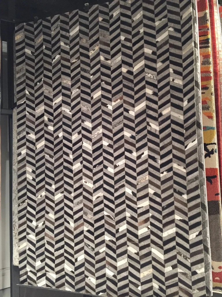 This is a blend of cowhide and a synthetic material (if I remember correctly)–great way to get the hide look at a fraction of the price.