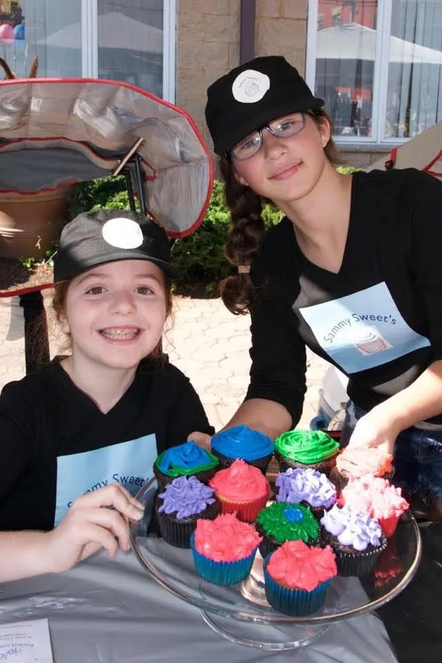 11 year old Samantha Cohen (Standing) and her friend sell cupcakes at Samantha's successful cupcake stand, Sammy Sweet's.