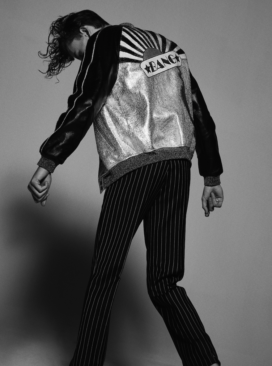 Ryan wears t-shirt by Billy LA , trousers by Dior Homme , jacket by Saint Laurent , shoes by Vans and necklace stylist's own.