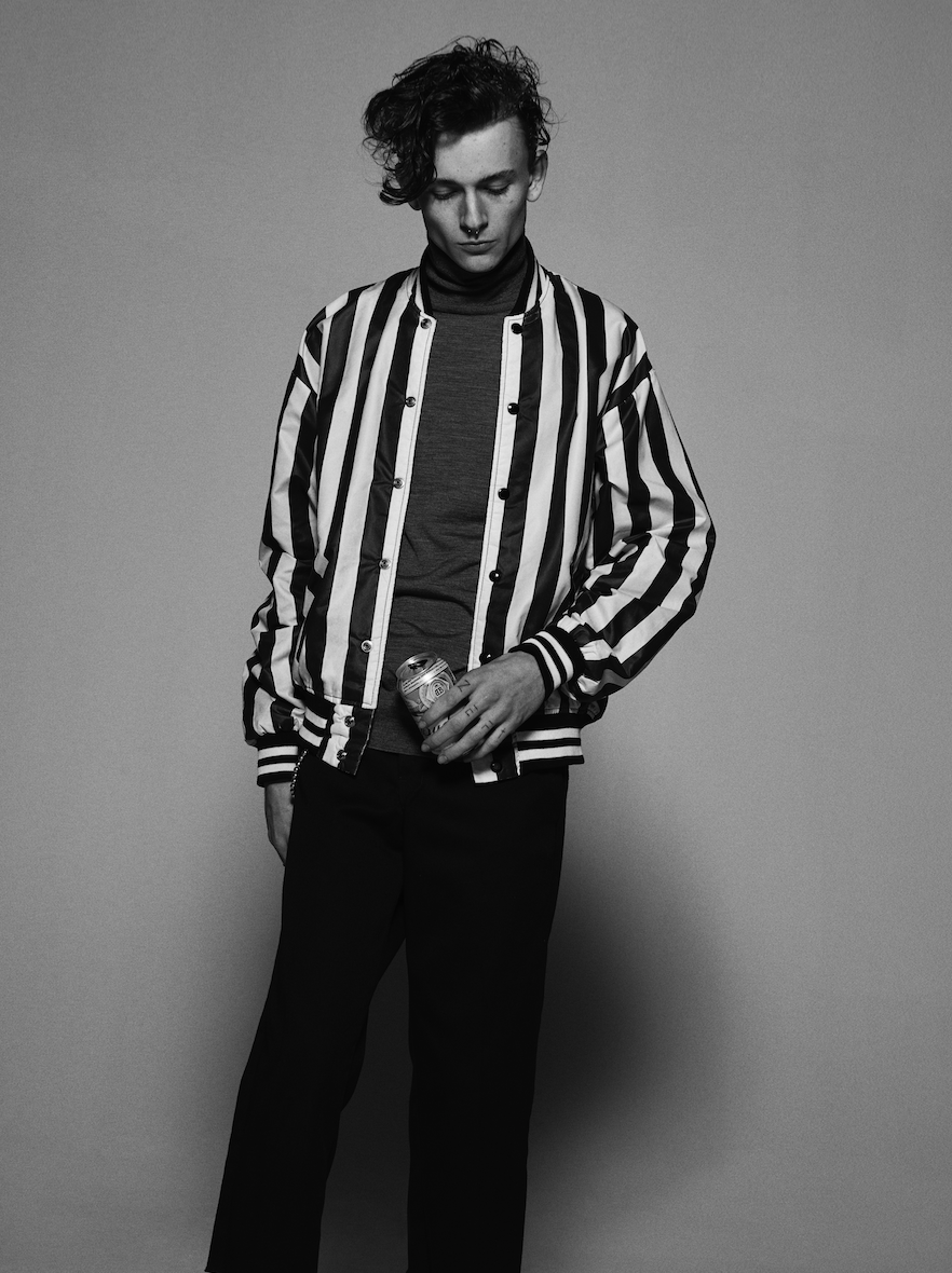Ryan wears turtleneck by Prada , trousers by Dickies , jacket by Billy LA , shoes by Saint Laurent and socks by Adidas .