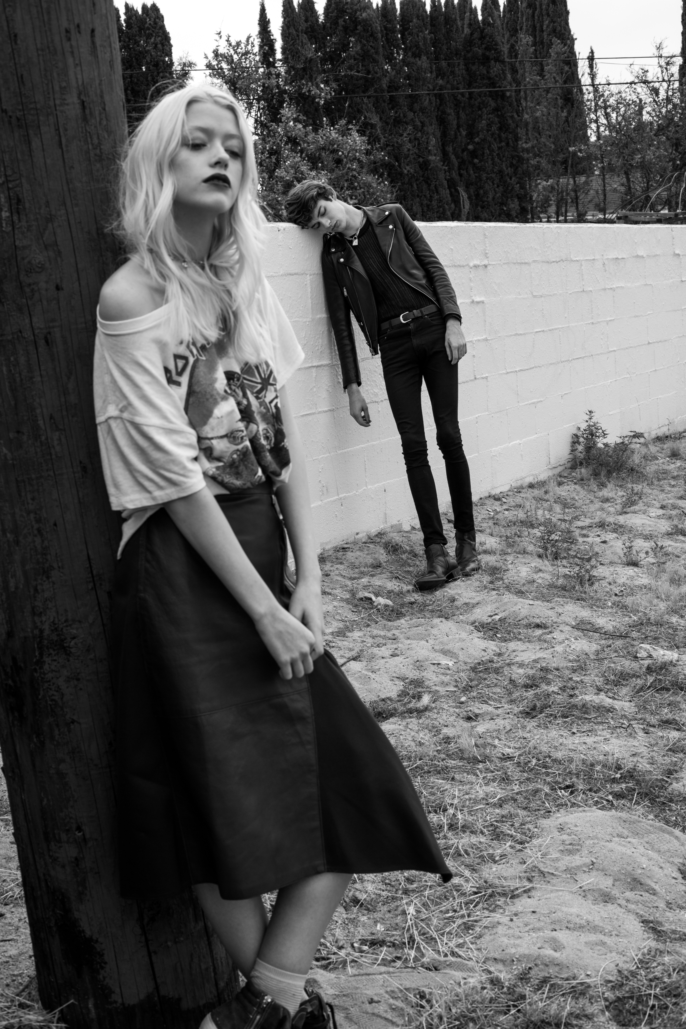 Jack wears mesh top by The Kooples , jeans, jacket and necklace by Saint Laurent , belt vintage . Cynda wears top by Madeworn from Kin Los Angeles , skirt by Phillip Lim from Kin Los Angeles , and shoes by Golden Goose from Kin Los Angeles.