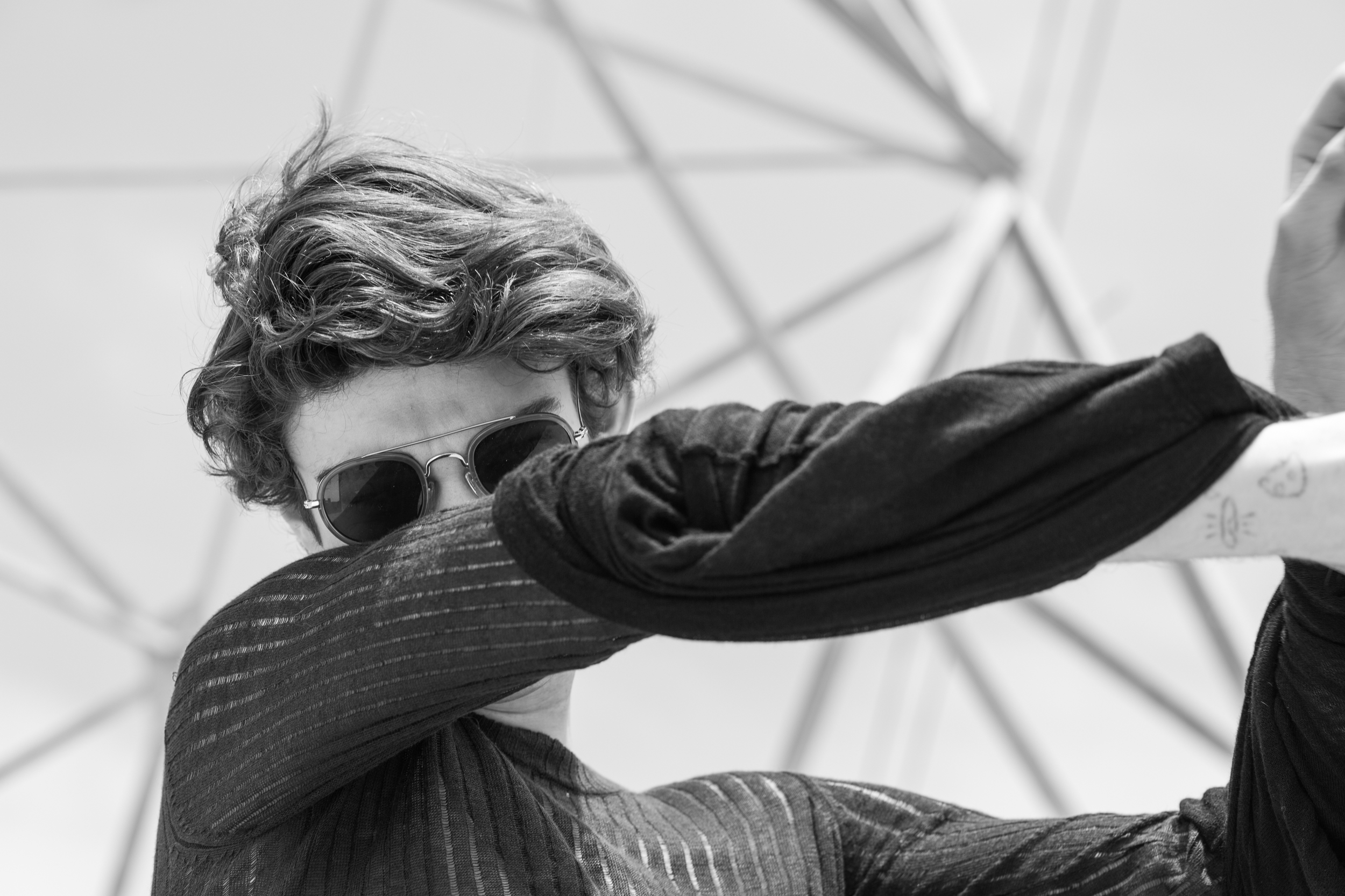 Jack wears mesh top by Rag & Bone , long sleeve top by The Squad and sunglasses by Urban Outfitters .
