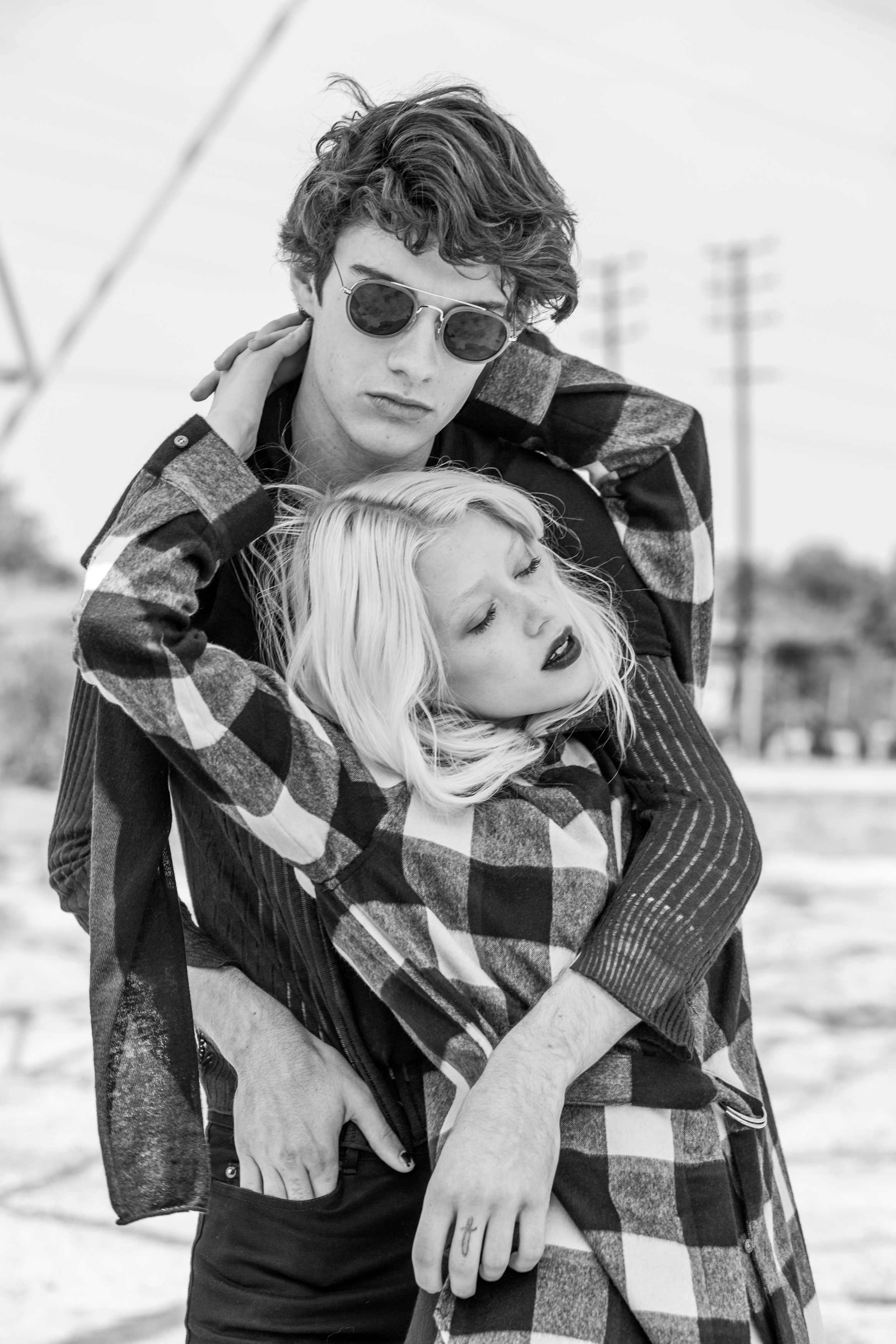 Jack wears mesh top by Rag & Bone , jeans by Saint Laurent , long sleeve top by The Squad and sunglasses by Urban Outfitters . Cydna wears top vintage , and oversized button up by Phillip Lim .