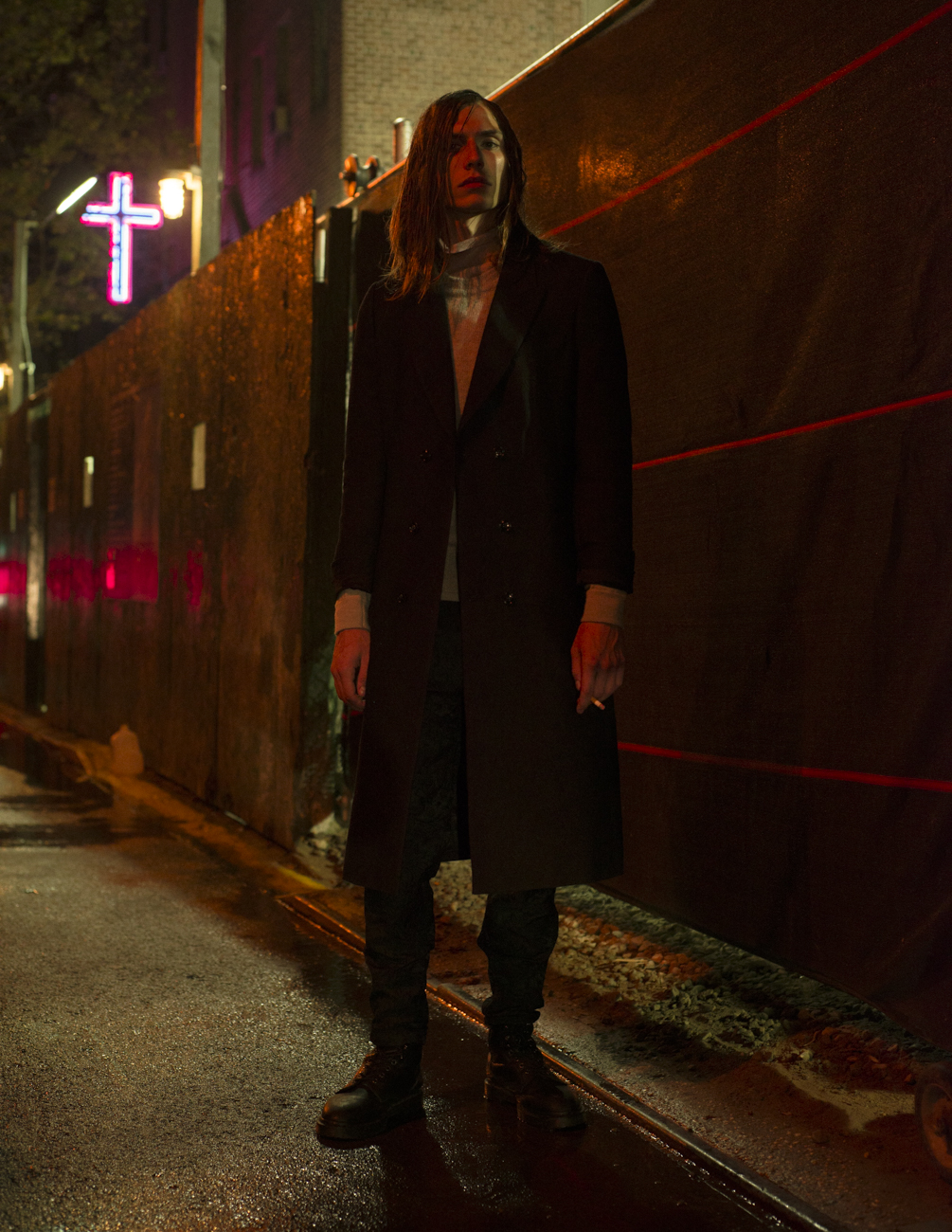 Andrew wears jacket by Berluti , turtleneck by Tim Coppens , sweater by Acne Studios , pants by Dior Homme and boots by Doc Martens .