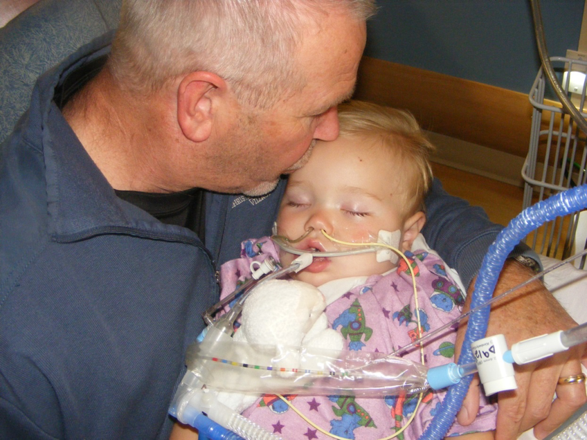  Caleb in his father's arms while in the hospital. 