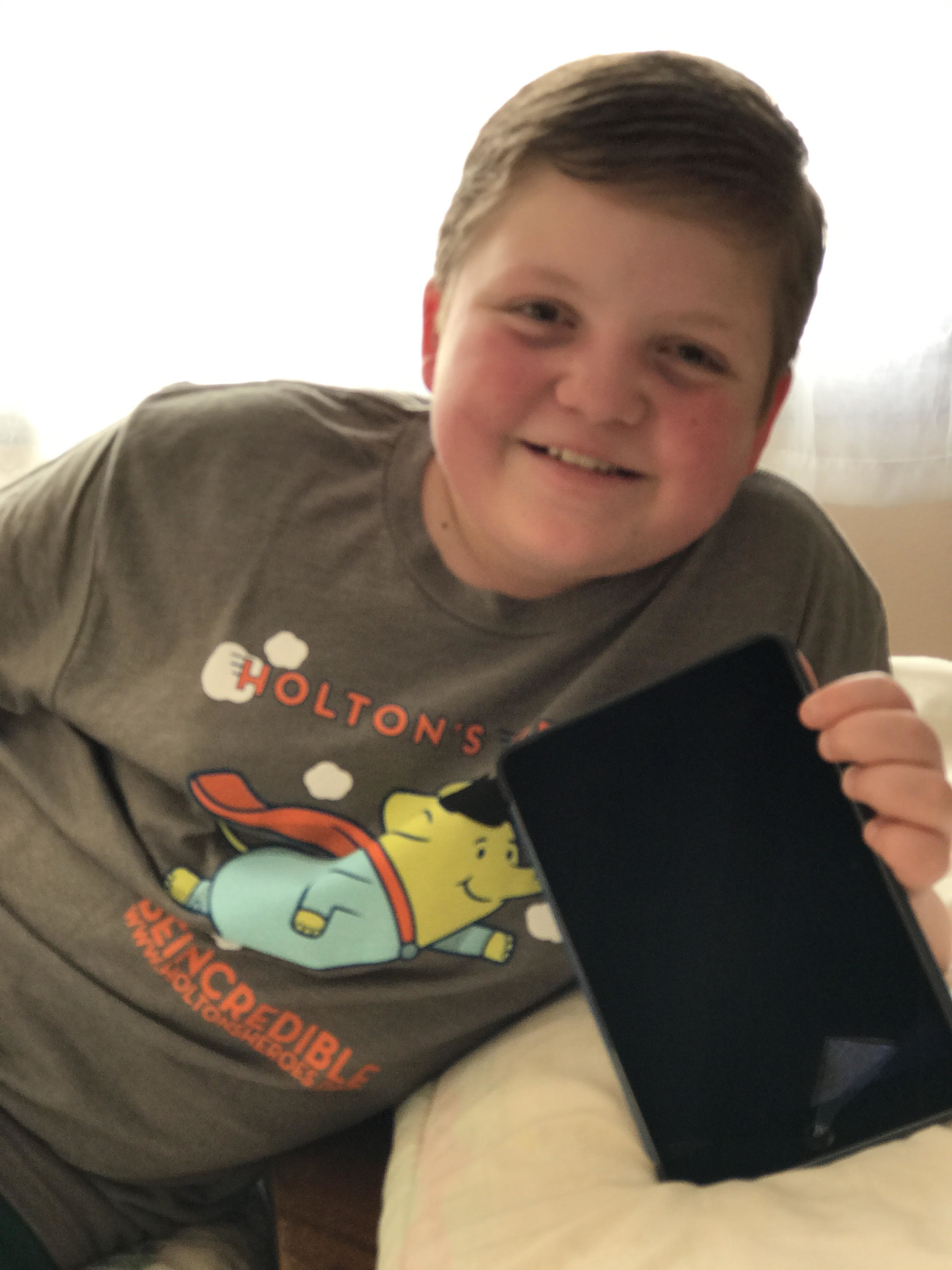  Owen rocking his HH shirt while displaying his new iPad mini for therapy 