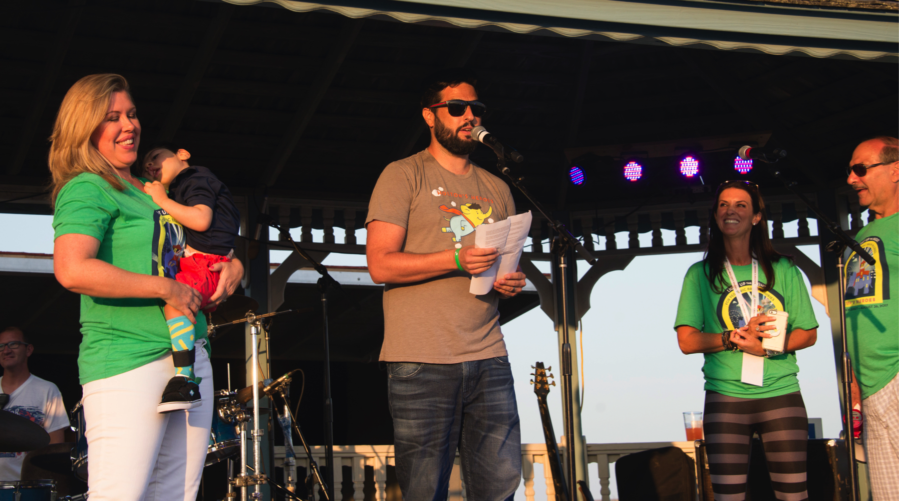 Co-Founder Eric Weingrad speaks to the crowd alongside his wife Angela and his son Holton.