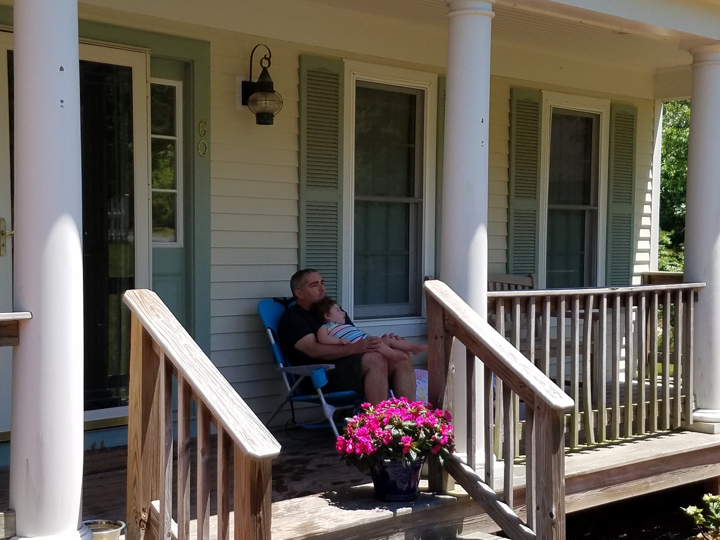 Leila and her dad relax on porch