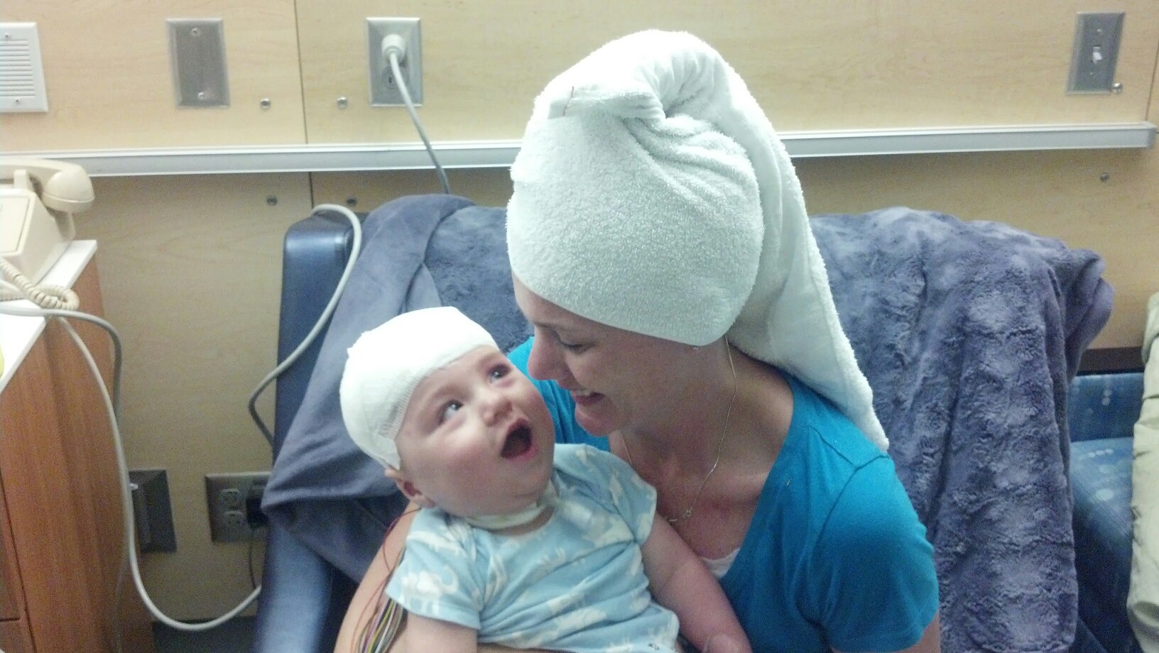 Mom making her boy laugh with her twinning hair style.