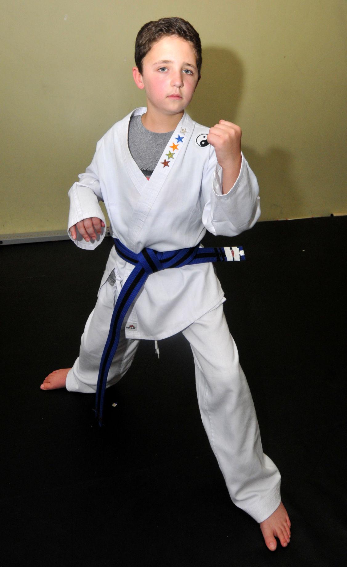  Chase strikes an intimidating karate pose post-stroke.  Photograph by Carl Kosola 