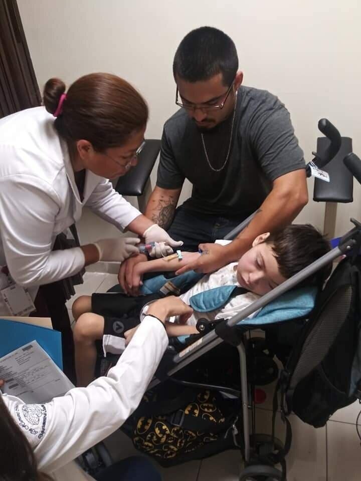  Josiah getting blood drawn in his old, under-sized stroller. 