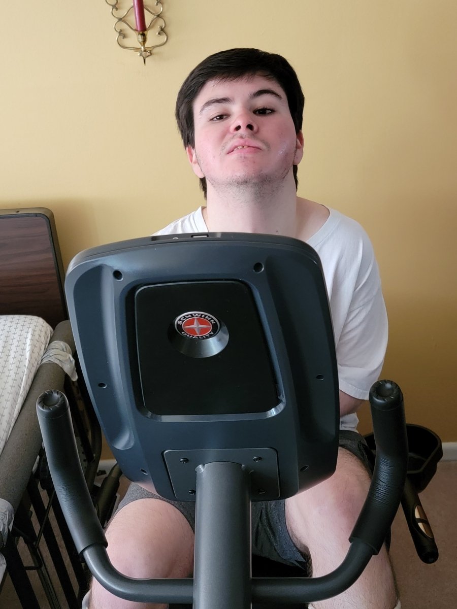 Noah using his new recumbent bike at home