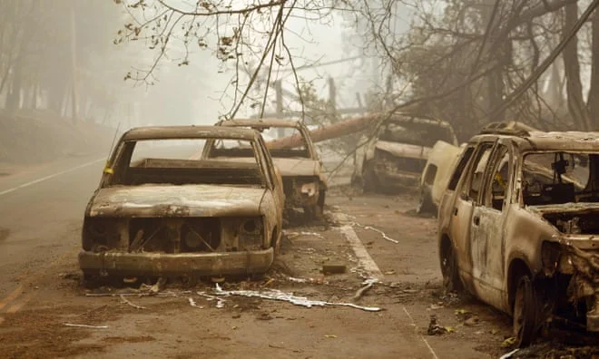 Burnt-out vehicles are seen on the side of the road in Paradise, California Photograph: Josh Edelson/AFP/Getty Images PHOTO CREDIT: https://www.theguardian.com/world/gallery/2018/nov/12/california-wildfires-trail-of-destruction-in-pictures