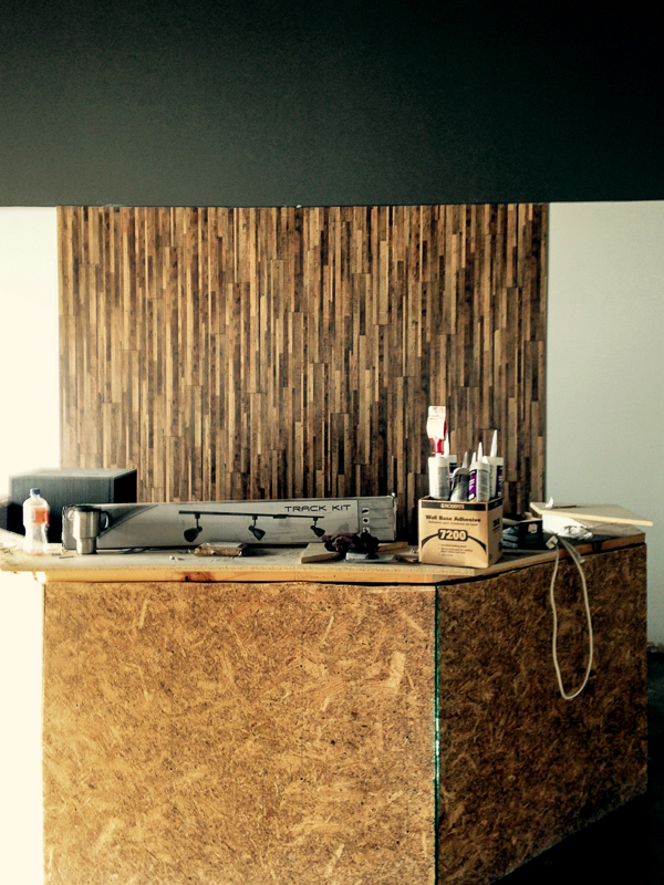 Note the reclaimed wood on the wall behind the framework for the expansive new front desk area.