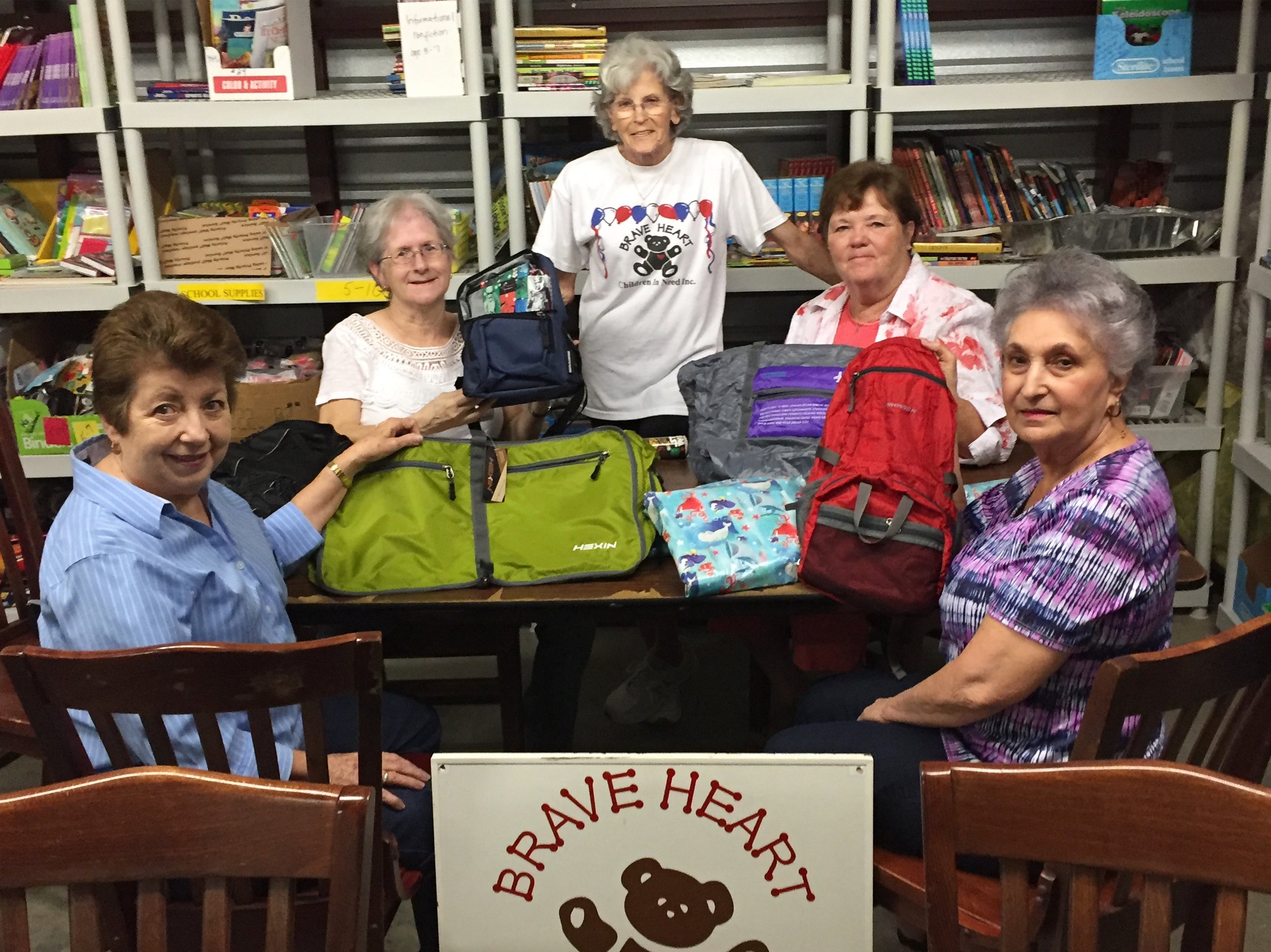   Program Coordinator, Marcy, poses with volunteers  