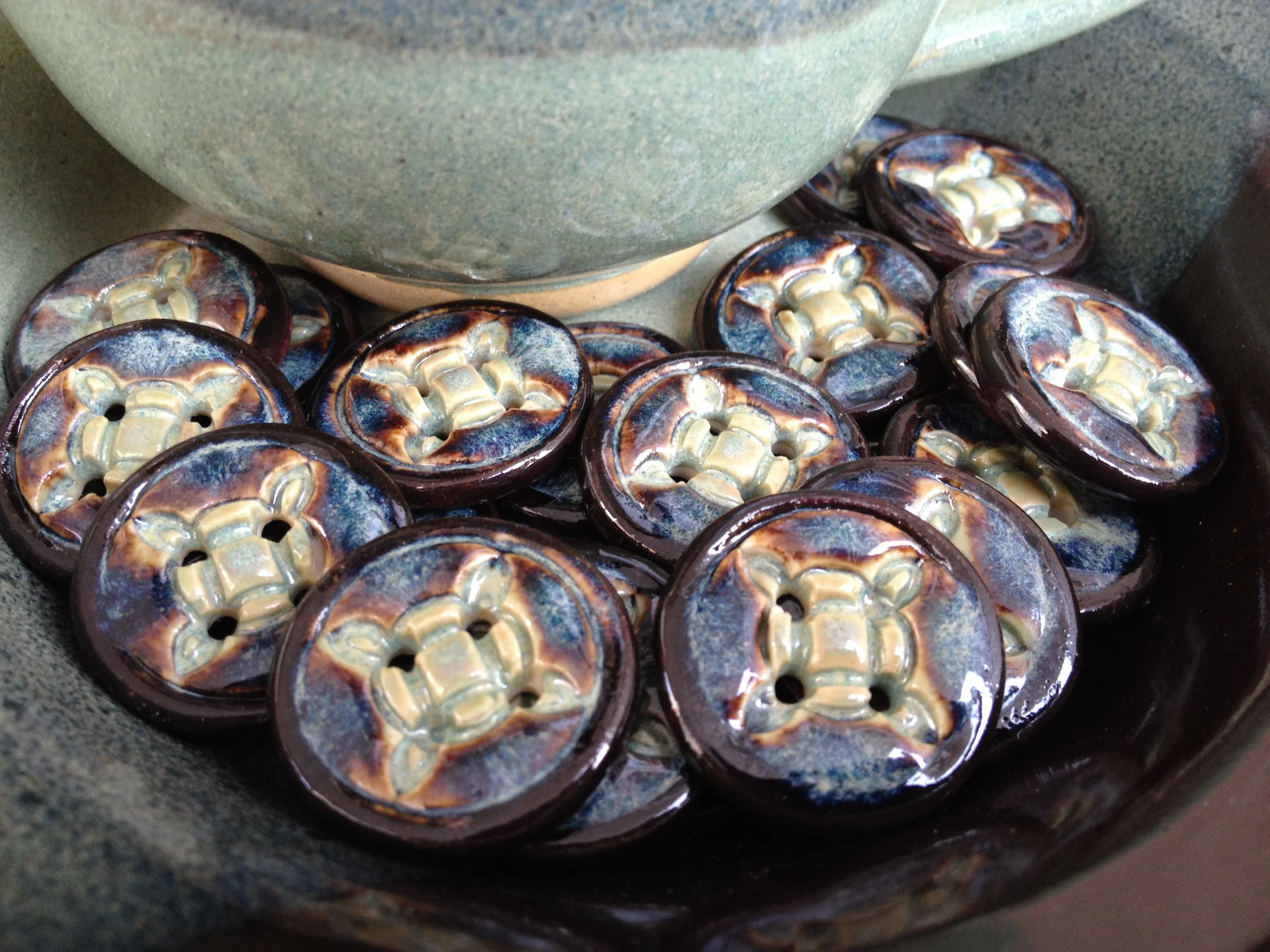 Close-up of Celtic Buttons with Temmoku and Jade Green Glaze