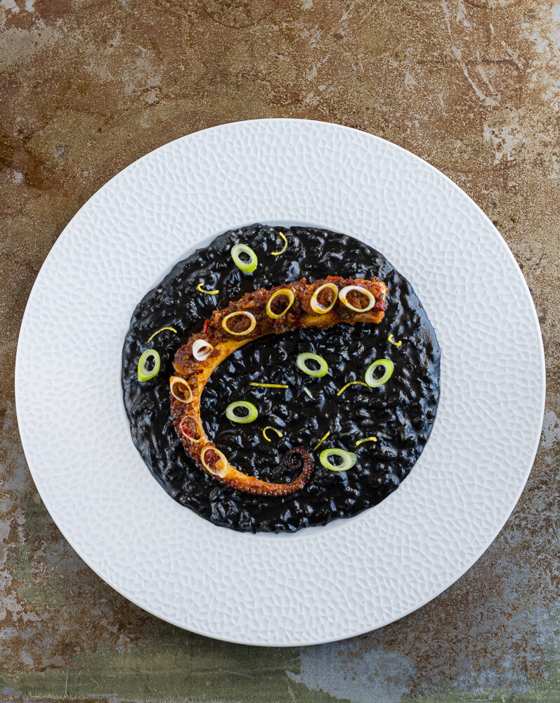 Seared octopus with nduja, risotto nero, Restaurant food photograph