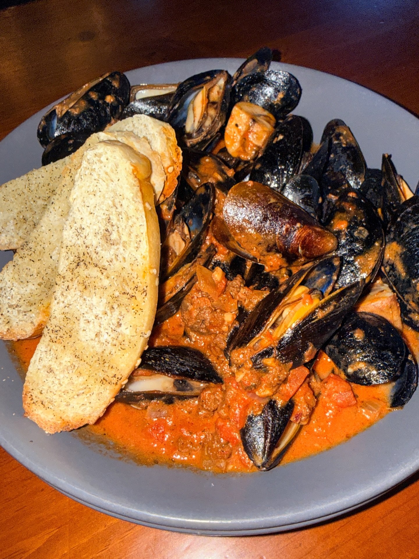 Treat yourself to our mussels with creamy red sauce, chorizo, wild mushrooms, and crostini 🥂✨