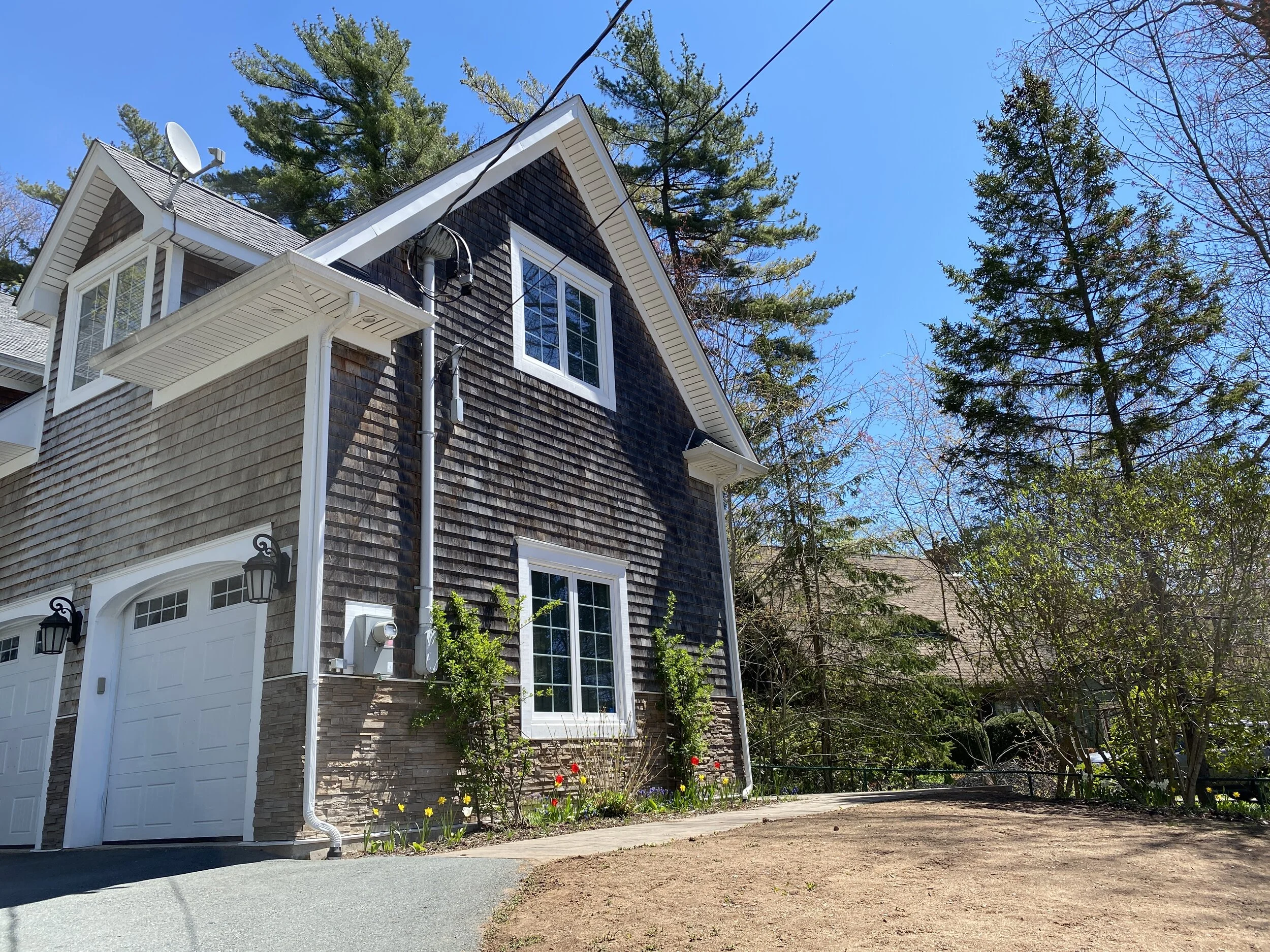 Weathered cedar shingles, gables, climbing roses and wisteria cascading on a courtyard arbor are hallmarks of coastal charm…perfect for the traditional style of this Shore Drive home.  Invasive goutweed on three neighboring properties had made its w