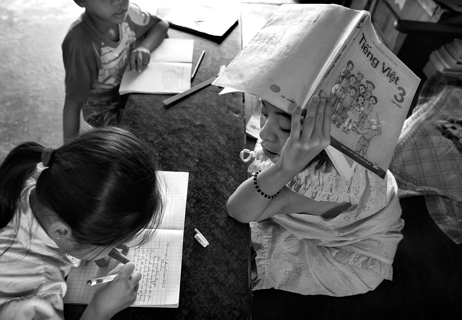 Thao tutoring local children from the village in her library. ~ Stephen Katz