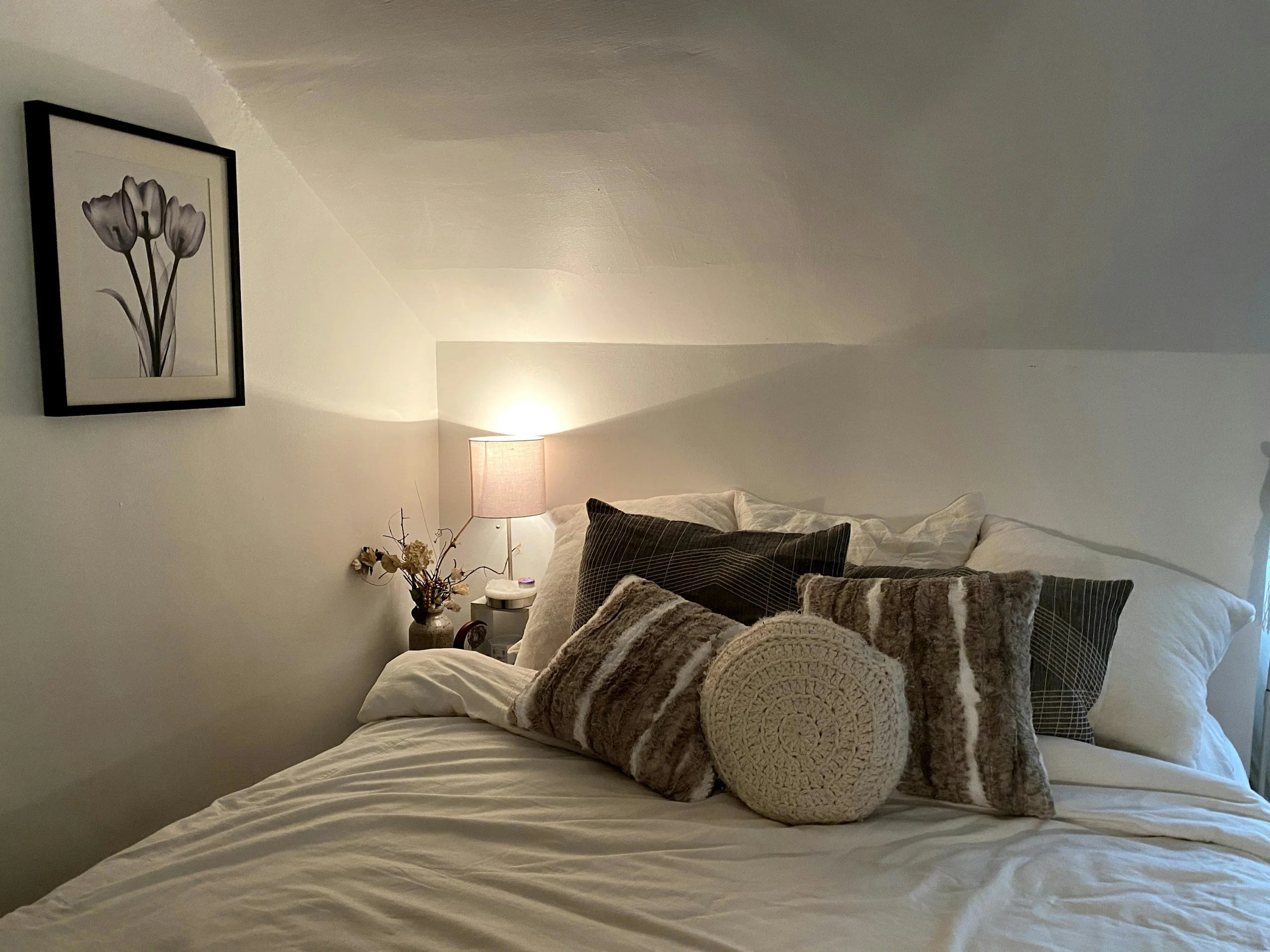 photo of a bed with bed lamp on