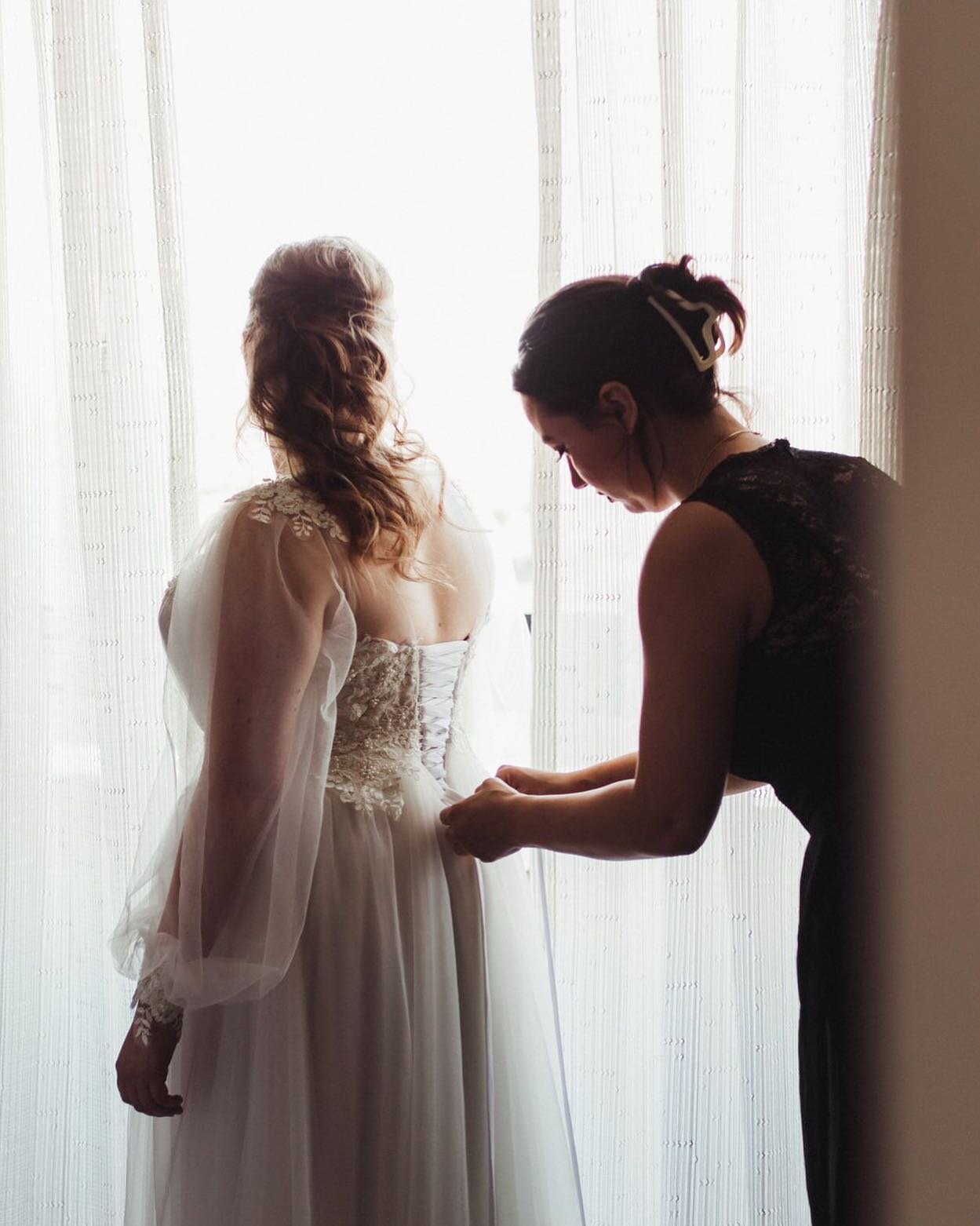 This is such a special photo. Let me tell you why- the maid of honor is helping the bride into her dress that was MADE by the MOH herself. SHE. MADE. IT. It was so special to be a part of this day. Would you trust your MOH to hand-make your wedding d
