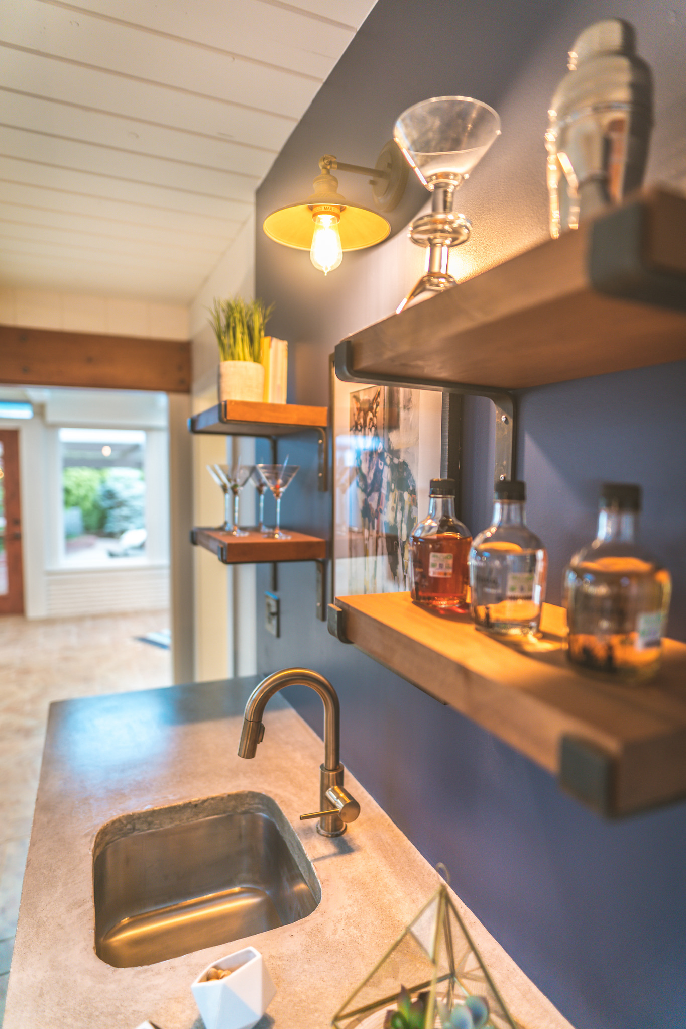 Custom shelving and concrete counters match the kitchen