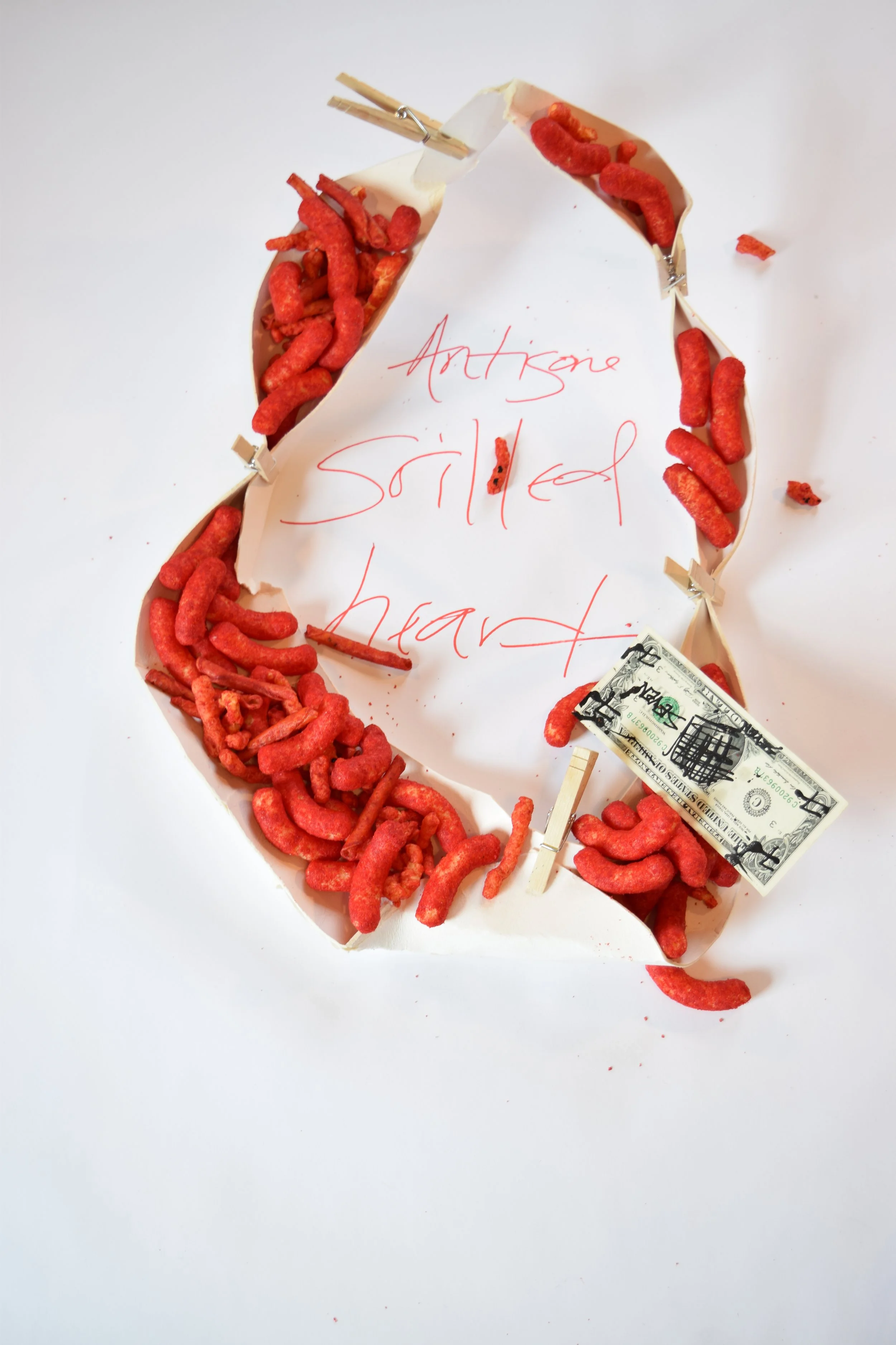 2016-04-16 16.35.22 Robert Fernandez, Antigone Grilled Heart, 2016. Digital photograph, Cheetos, red and black paint, a dollar bill, clothes pins, thick structural paper, and base paper..jpg