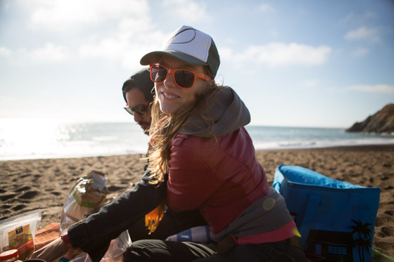  Couple on California beach having a picnic with the ocean in the background. 