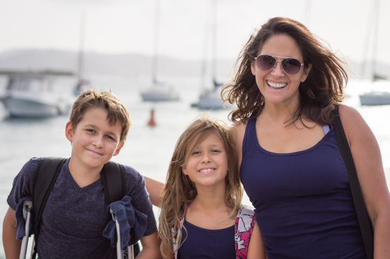  Close up of family with two children with sailboats in the background. 