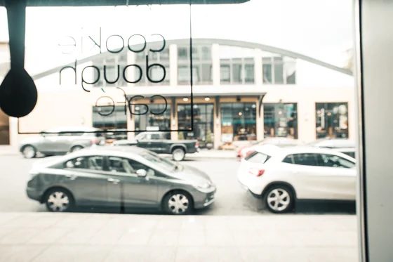 Looking out of front window of the Cookie Dough Cafe to the cars along the street.