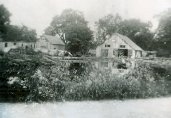  This image, contributed to The Tweed News by Mrs. Lorraine Shea of Tweed, shows Lost Channel as it appeared in the 1940s. The sawmill is the building to the right. The centre building housed the waterwheel. Broom handles and cheese boxes for the area’s many cheese factories were produced in the building to the left. This once busy industrial site also contained a gristmill and a veneer-making building, both of which lay outside the reach of this photograph.