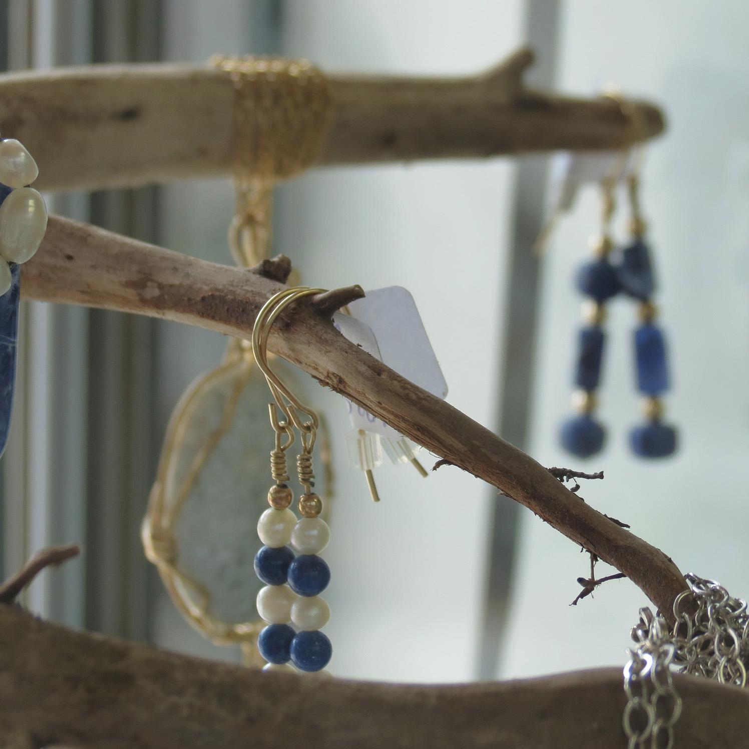 In addition to her work with driftwood and painting, Monteith is also a lapidary jewelry designer