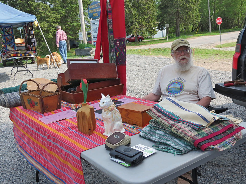Poet Peter Jones is a market regular signing copies of his books and sharing selections with patrons.