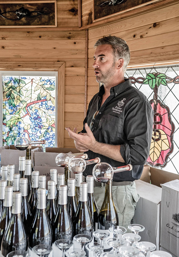 Johnson loves sharing his high-end small-batch artisinal wine with visitors to Potter Settlement. Photo by Gail Burstyn