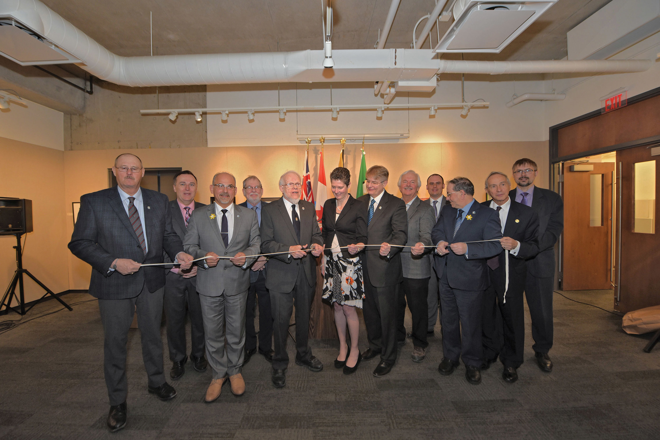 The new home for the Community Archives of Belleville and Hastings County was officially opened on April 7. Present at the ribbon-cutting were (l to r) Rick Phillips (Hastings County Warden), Neil Ellis (Bay of Quinte MPP), Taso Christopher (Belleville Mayor), Orland French (Hasting County Historical Society Past President), Gerry Boyce (HCHS Historian), Amanda Hill (HCHS Archivist), Mark Fluhrer (Director, RC&CS Belleville), Joel Carr-Braint (Belleville Property Manager), Trevor Pross (Belleville Library CEO), Garnet Thompson (Belleville Councillor), Richard Hughes (HCHS President) and John Roberts (Ontario Archivist). Photo by Bob House / courtesy Community Archives of Belleville and Hastings County