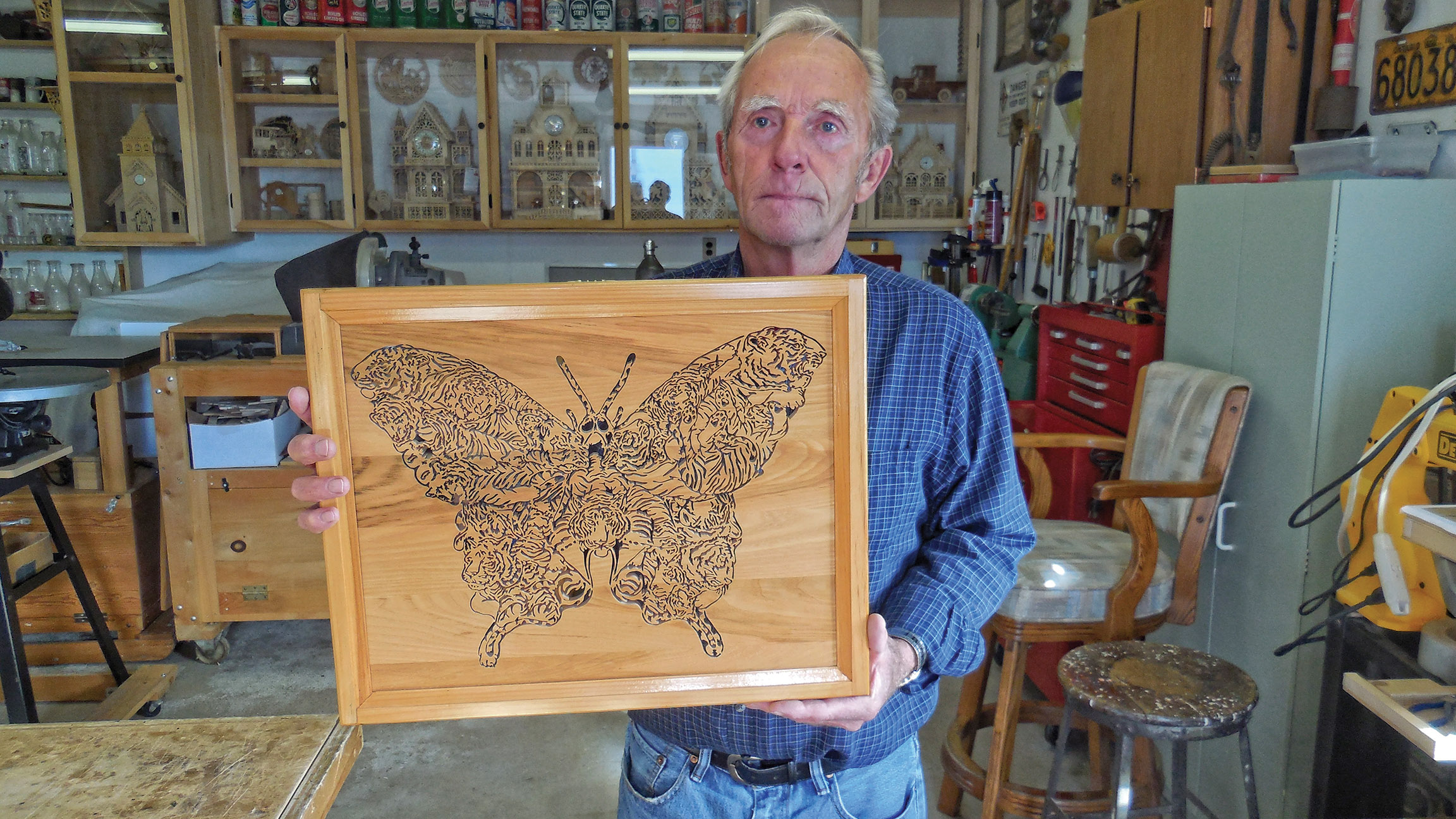 Wood-worker Glen Finch shows off the intricate cut-out of a Tiger Butterfly, one of the most challenging pieces he has produced. “I had to take a break and go back to it,” he admits. Photo by Angela Hawn