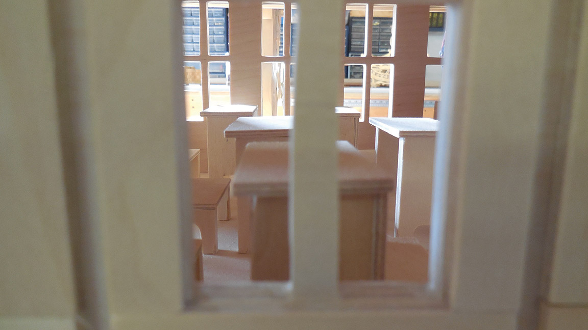 Finch’s exacting standards can be seen in the miniaturized version of his former school house, which has been reproduced down to the tiny desks and chairs visible through the windows. Photo by Angela Hawn