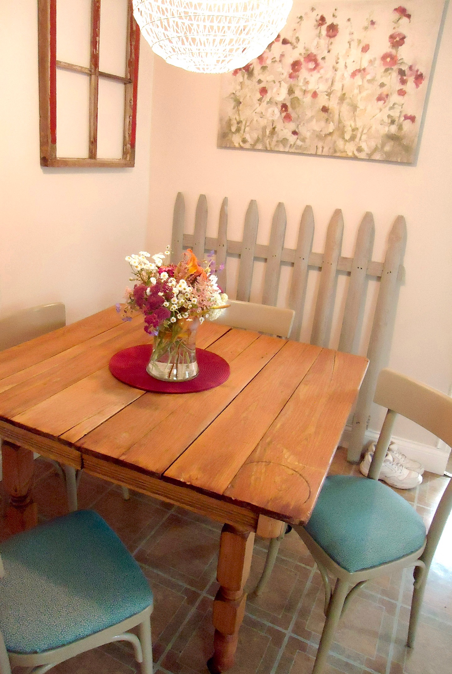 Inspiration can be found anywhere. This picket fence and the worn old red barn windows now live inside the house in a lovely freshly painted kitchen.