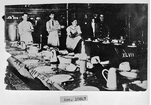 Period photograph of a Whitney area lumber camp at the eastern limits to Algonquin Pa rk. Cooks and cookies pose at tables set for the arrival of an always ravenous gang of shanty men. Archives Ontario, Penhale Collection.