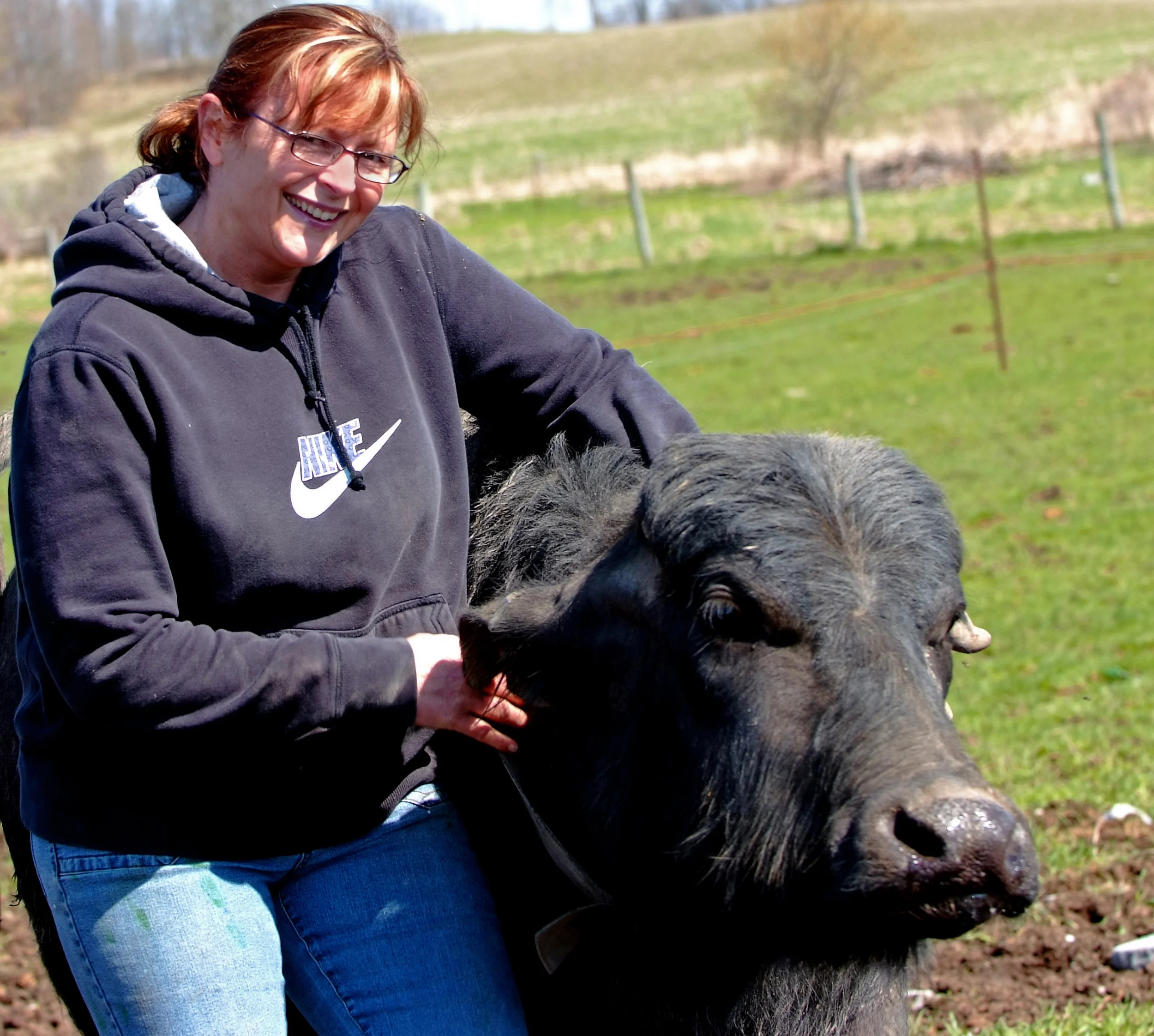 Lori Smith and one of their herd. Smith considers water buffalo to be animals of impressive intelligence.