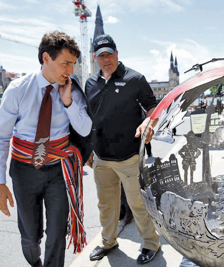 Shawn Donnan with Prime MInister, looking at the Canada 150 fire globe on Parliament Hill.jpg
