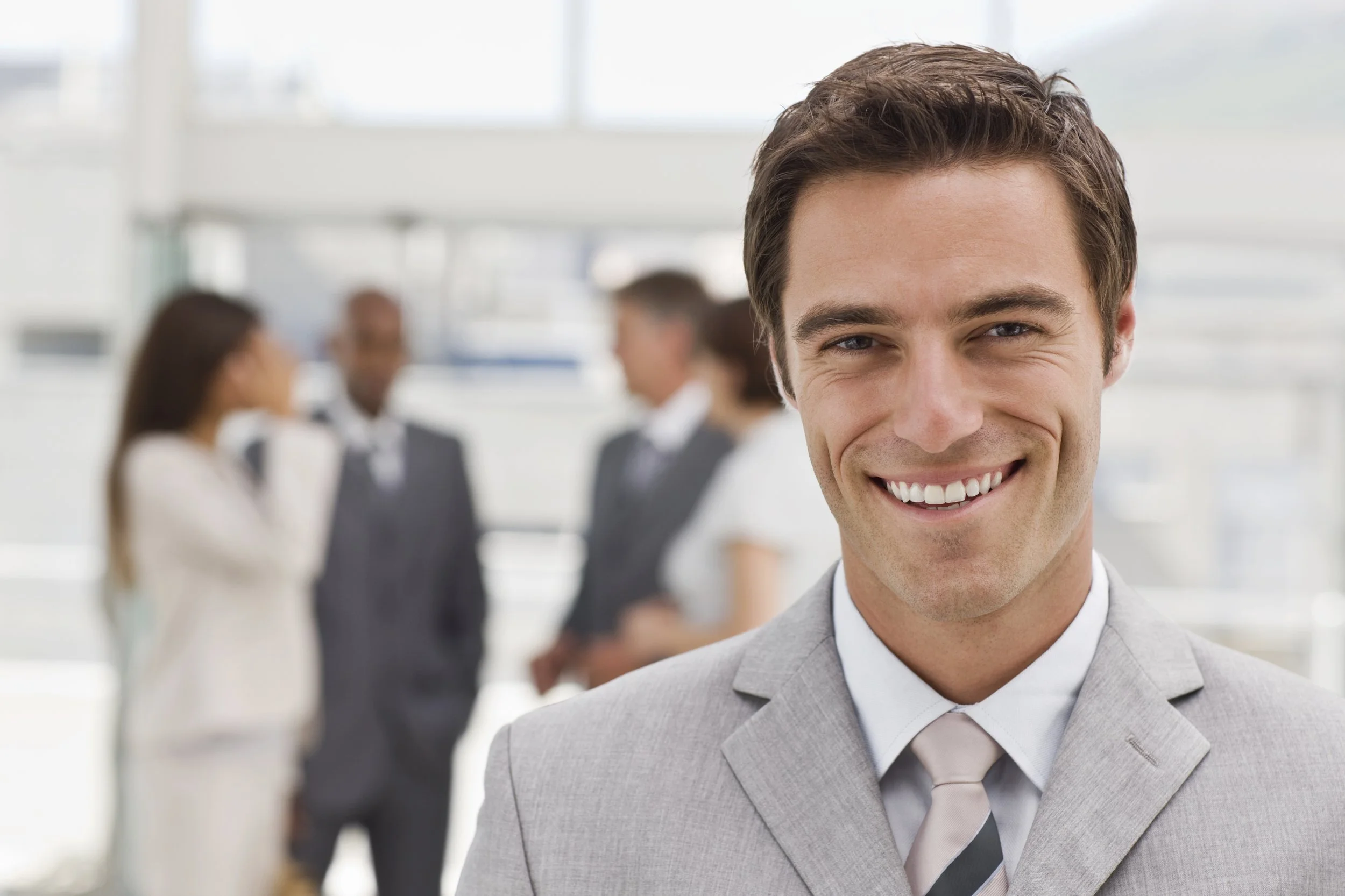 Portrait-of-happy-young-businessman-000007068613_Large.jpg