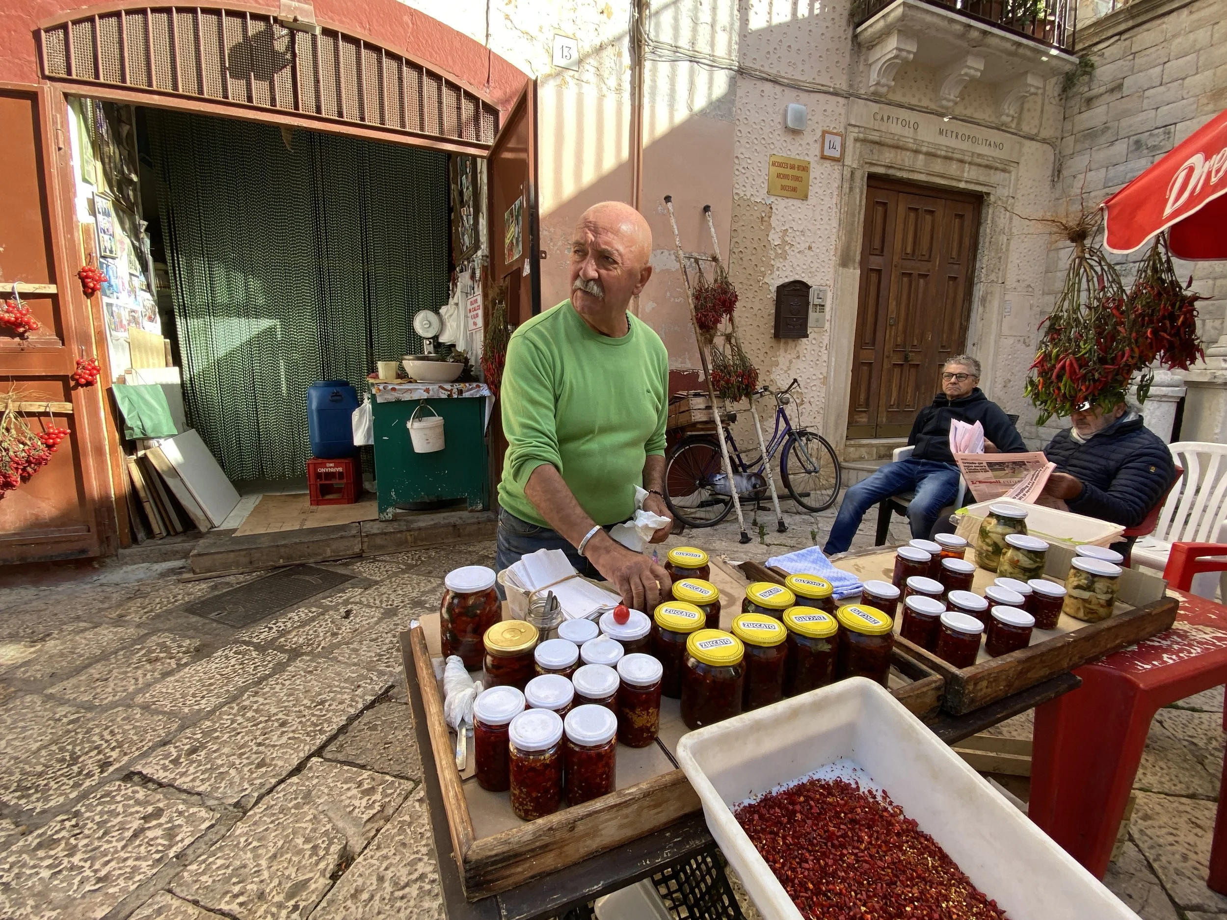 man selling peppers and tomatoes in Bari, Puglia